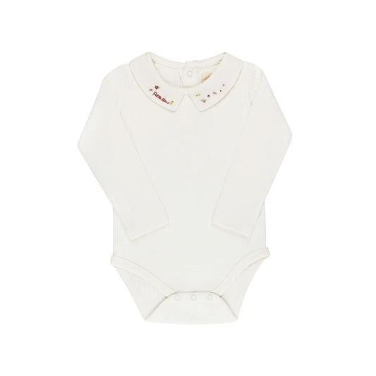 Cream long-sleeve knit bodysuit with colorful floral star embroidery on Peter Pan collar