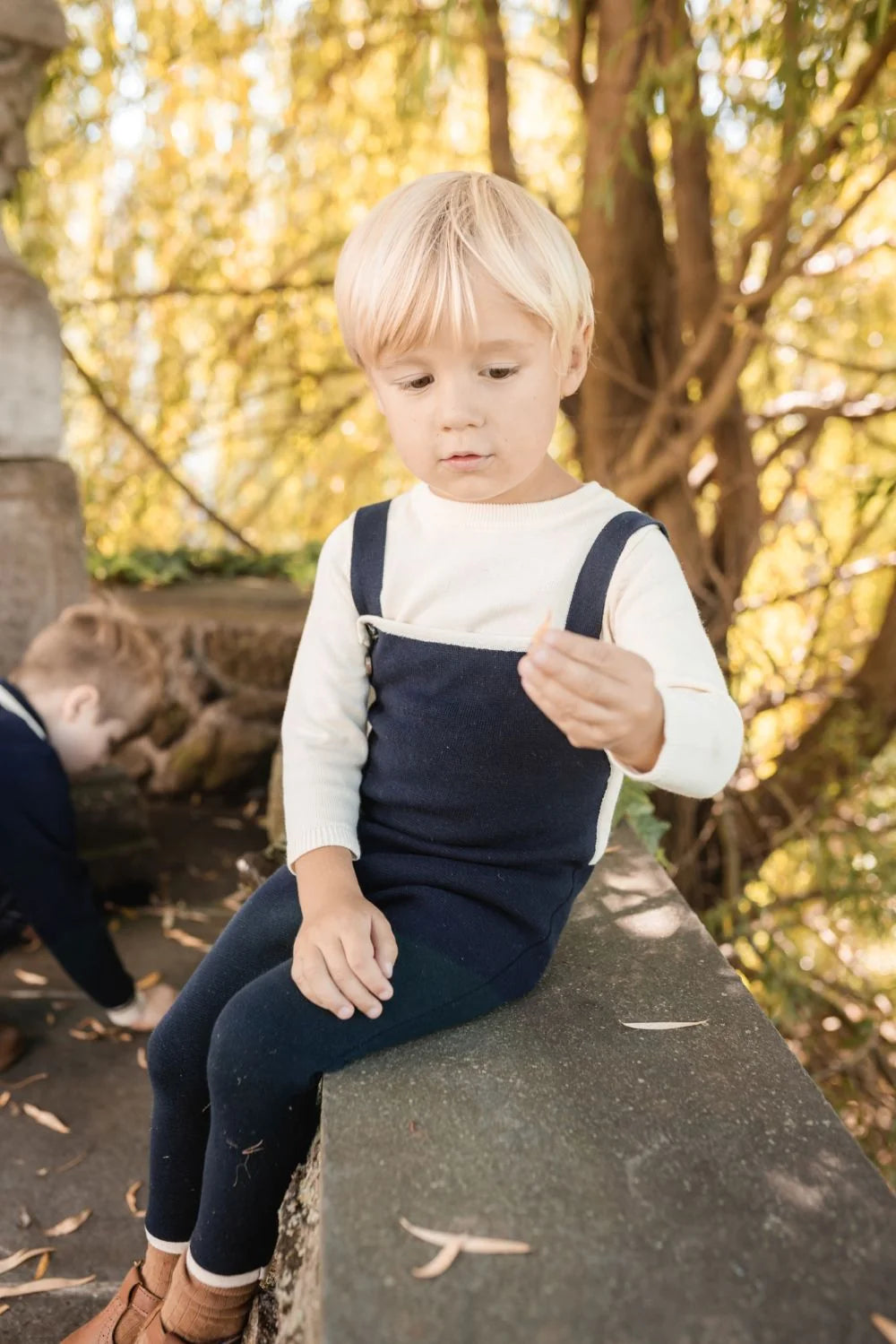 Toddler knit trim overall set with dark navy overalls and white long-sleeve top