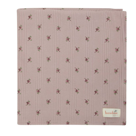 Lavender ribbed blanket with small floral print and woven brand label