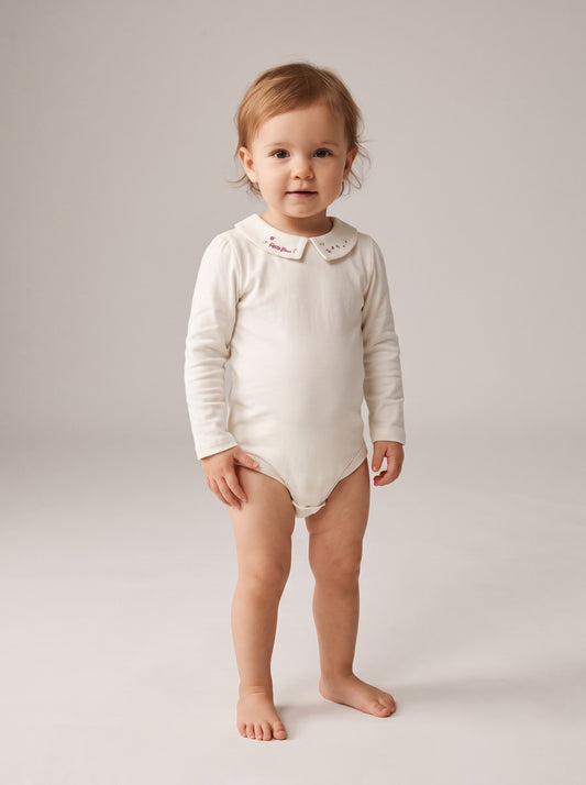 Long-sleeve knit bodysuit with collared neckline and snap leg closure, light color