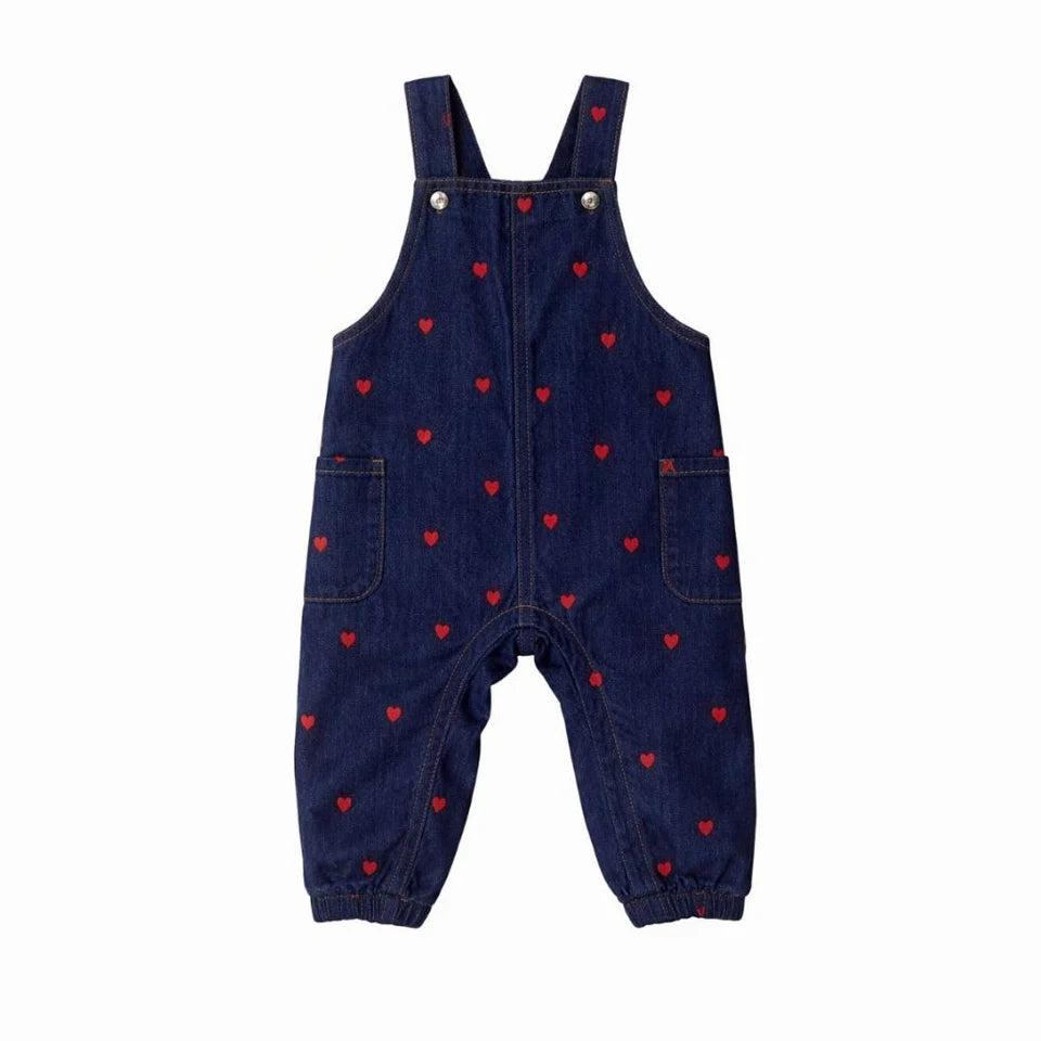 Dark blue denim overalls with red heart print, adjustable straps, button bib